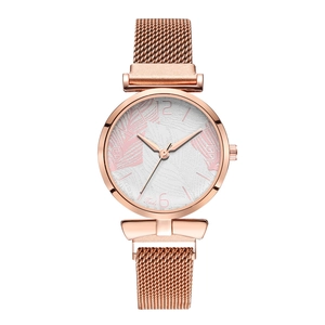 Detail of rose gold mesh strap and white watch face with delicate leaf textures