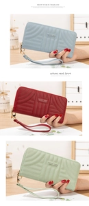 Detail of long zippered wallets in various colors with elegant wave pattern stitching