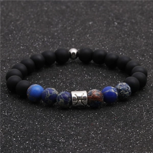 Detailed shot of Pisces constellation bead bracelet with matte black and blue stones