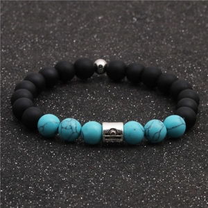 Macro view of Libra zodiac bead bracelet with matte black and turquoise stones