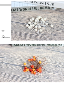 Detailed view of 8mm pearlized white and orange artificial foam berries for DIY crafts