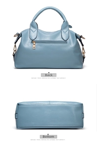 Detail of the litchi texture handbag back zipper and bottom stitching in blue leather