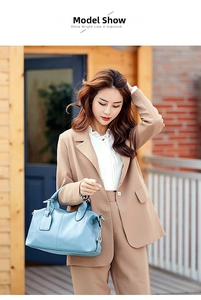Light blue lychee pattern Boston handbag styled with a camel suit on a fashion model
