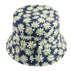Close-up of small white daisy print on dark blue cotton reversible bucket sun hat
