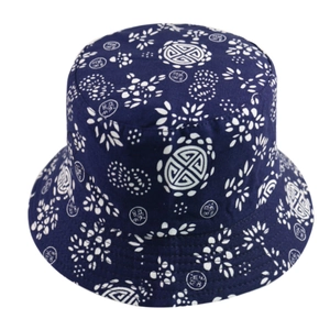 Close-up of navy blue bucket hat with traditional white floral print patterns