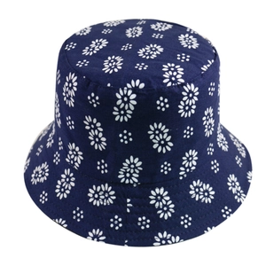 Close-up view of the white floral print on a navy blue foldable cotton bucket hat