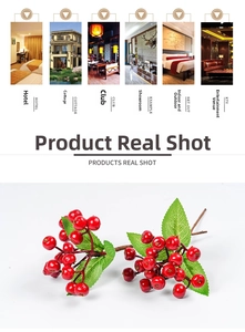 Detailed view of artificial red berry stems with green leaves for home decoration