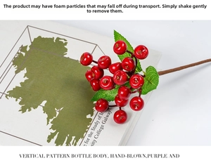 Detailed view of artificial red berry branches with glossy finish on a white book