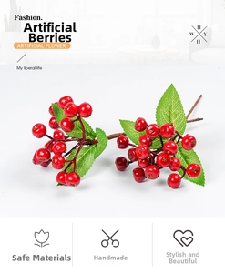 Close-up of artificial red berries with glossy finish and green leaves for home decor