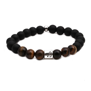 Tiger eye and matte black stone beaded bracelet featuring silver Capricorn zodiac charm