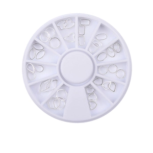Macro shot of silver metal nail art studs in a rotating round storage wheel container