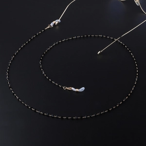 Golden eyewear chain with black triangle crystals and anti-slip silicone loops