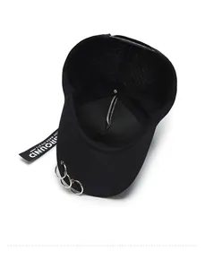 Close-up of black cotton baseball cap interior with metal rings and lettered ribbon detail