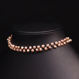 Elegant zigzag natural freshwater pearl choker necklace in pink-orange on a black neck stand