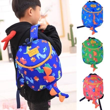 Three colorful children dinosaur backpacks in blue, green and red with 3D fins