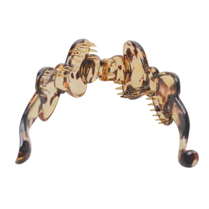 Detailed view of durable tortoiseshell resin banana hair clip with secure metal hinge