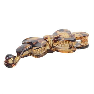 Detail of tortoise shell banana hair clip with internal teeth on white background