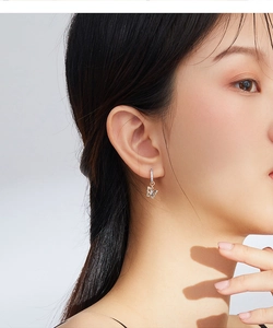 Close-up of a model wearing a S925 sterling silver butterfly earring with zircon stones