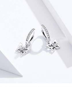 Detail of silver butterfly pendant hoop earrings with sparkling cubic zirconia pavé