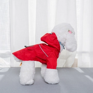 Detail view of red waterproof pet raincoat with reflective strips on dog model