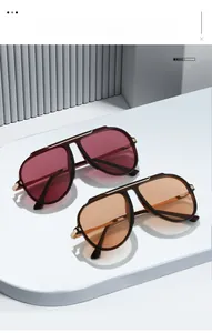 Detail view of oversized pilot sunglasses with gold metal double bridge and premium frame