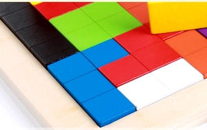 Close-up of colorful wooden Tetris puzzle blocks with smooth finish and natural base