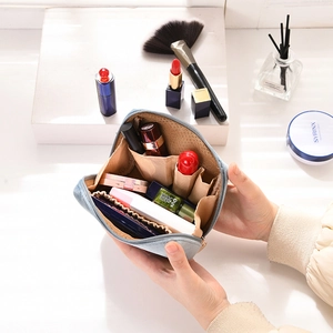 Internal view of light blue plush makeup bag with multiple functional storage compartments