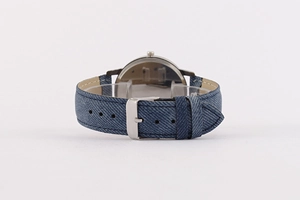 Detail view of the blue denim texture strap and silver metal buckle on a men's wristwatch