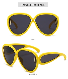 Vue détaillée des lunettes de soleil oversize jaunes avec verres foncés et accents dorés