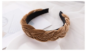 Detailed view of the khaki velvet braided headband with soft texture and wide twist design