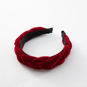 Braided velvet headband in dark red minimalist twist design on a white background