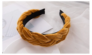 Detail of ginger velvet braided headband with anti-slip lining on elegant white background