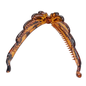 Detail view of open brown tortoise shell banana hair clip showing inner comb teeth