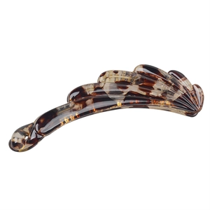 Close-up of a tortoise shell patterned banana hair clip with a glossy resin finish
