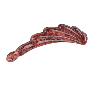 Detail of durable tortoise shell resin banana clip with glossy amber finish for women