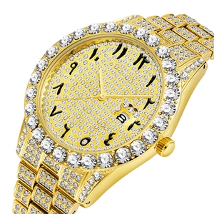 Macro view of gold iced-out watch with Arabic numerals and date window at six