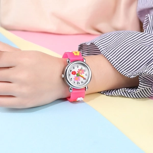 Close-up of pink children's watch with 3D floral silicone strap on a child's wrist