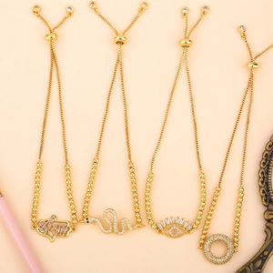 Detailed view of adjustable gold-plated bracelets featuring Hamsa Hand and snake charms