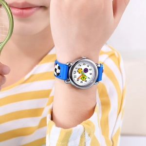 Close-up of kids sports watch with 3D soccer embossed blue strap on child's wrist