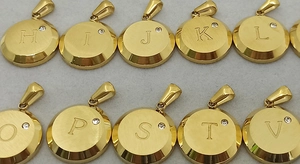 Close-up of 18K gold plated stainless steel round initial pendants with small diamonds