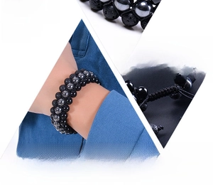 Detailed close-up of natural black lava stone and hematite beads on a triple-layer bracelet