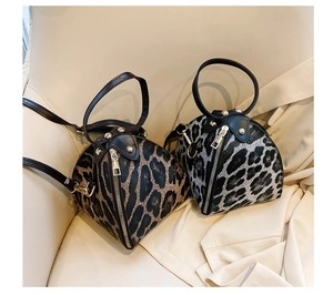 Detailed close-up of brown and grey leopard print mini handbags with metal zippers