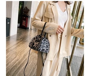 Detail of leopard print mini triangle bag with leather strap and top handle for women