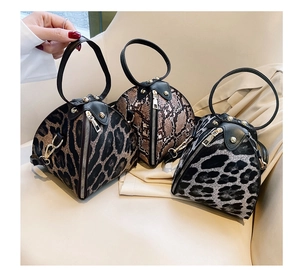 Detailed view of leopard and snakeskin print triangle handbags with metal ring handles