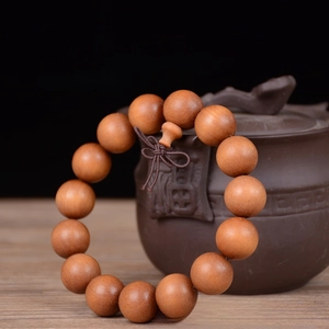 Detail of 15mm sandalwood prayer beads with traditional knot and premium small hole craft
