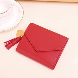 Red tri-fold faux leather wallet with heart pendant and tassel detailing