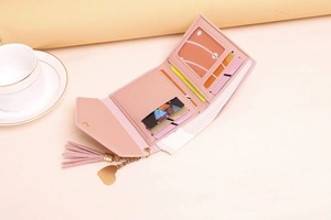 Pink trifold wallet interior view with card slots, cash compartment and heart tassel