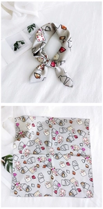Detail of grey silk scarf with poker prints and rolled edges in flat and tied views