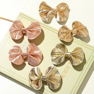 Set of six metallic faux leather butterfly bow hair clips in champagne gold and bronze