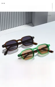 Macro shot of vintage square sunglasses with tortoiseshell temples on minimal white podium